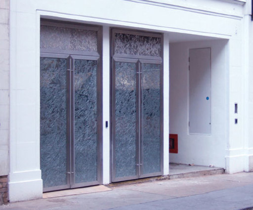 Set of double doors with grills over for Derring Street London, designed by Shelagh Wakely in three layer and then fixed together under glass, all panels are photo etched by Etch Tech to give the effect of fine lace. 